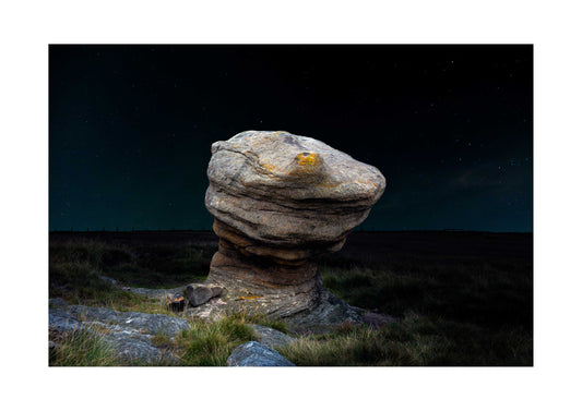 Stack of rocks with a dark starry sky background
